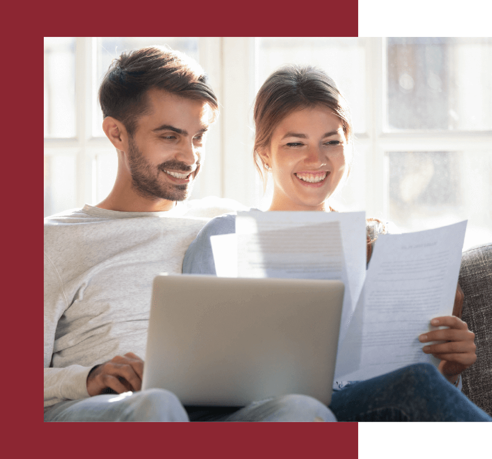 smiling couple looking at loan documents